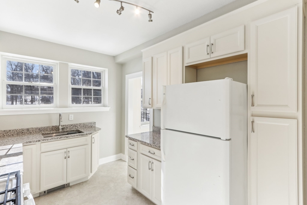 27 Elm Road, Unit D Devens, MA 01434 - Photo 11 of 31 a kitchen with granite countertop cabinets and refrigerator