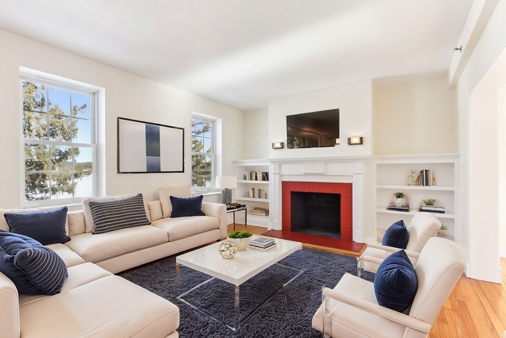 27 Elm Road, Unit D Devens, MA 01434 - Photo 4 of 31 a living room with furniture a flat screen tv and a fireplace
