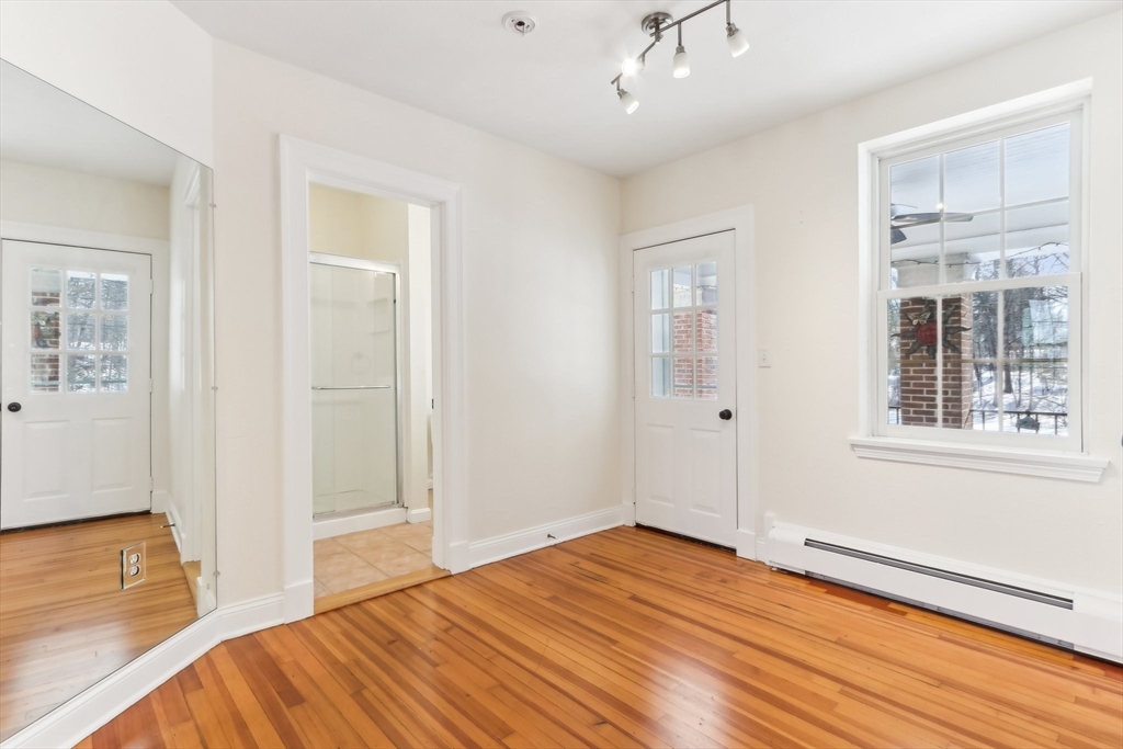 27 Elm Road, Unit D Devens, MA 01434 - Photo 7 of 31 an empty room with wooden floor and windows