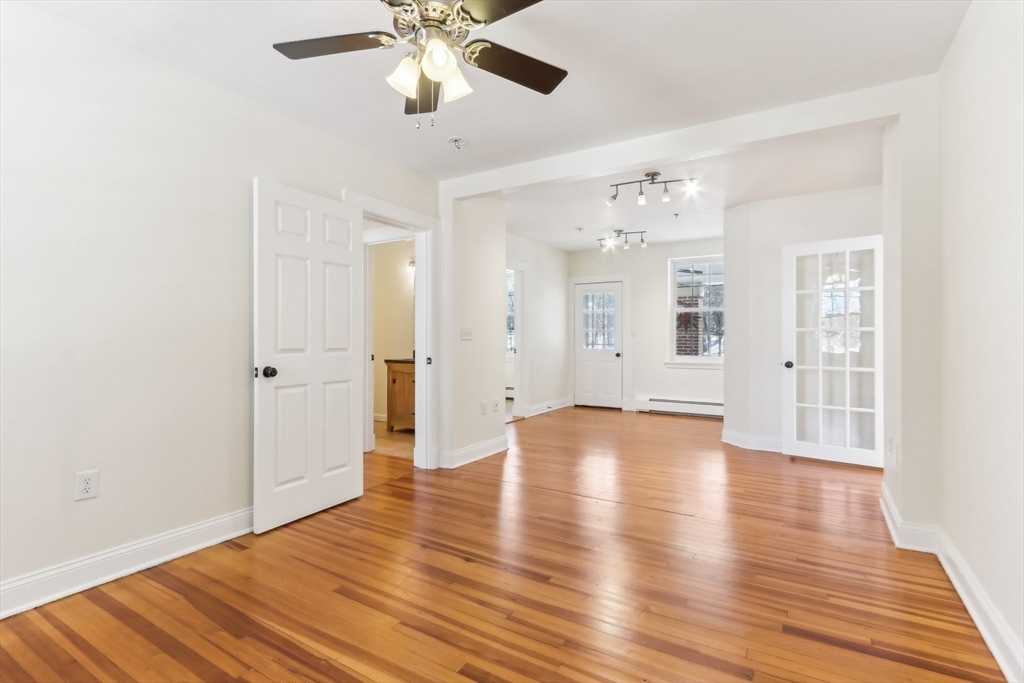 27 Elm Road, Unit D Devens, MA 01434 - Photo 8 of 31 a view of an empty room with wooden floor and a window