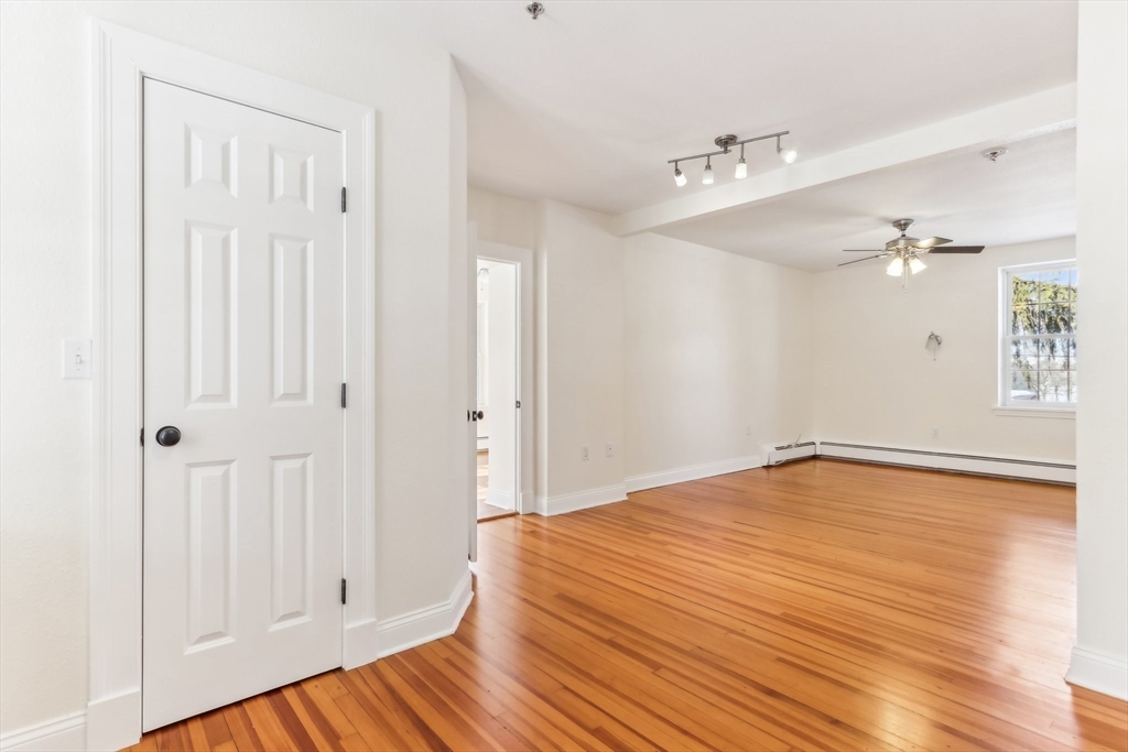 27 Elm Road, Unit D Devens, MA 01434 - Photo 9 of 31 a view of an empty room with wooden floor