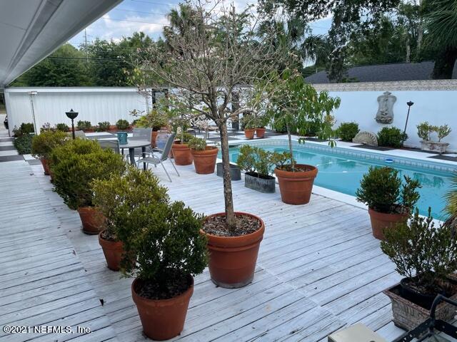 7124 St Augustine Road Jacksonville, FL 32217 - Photo 11 of 20 a view of a backyard with sitting area and potted plants