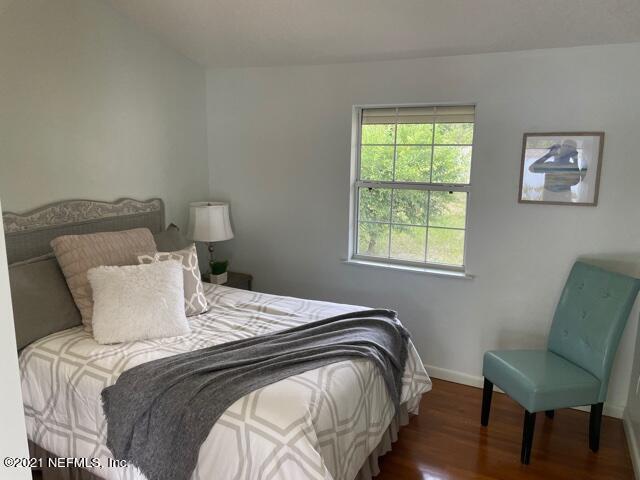 7124 St Augustine Road Jacksonville, FL 32217 - Photo 12 of 20 a bedroom with a bed and a chair