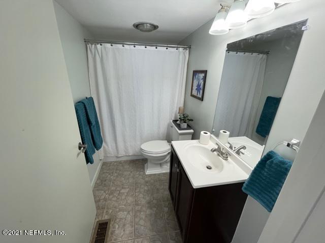 7124 St Augustine Road Jacksonville, FL 32217 - Photo 14 of 20 a bathroom with a sink a toilet and mirror