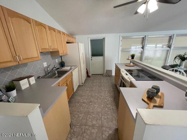 7124 St Augustine Road Jacksonville, FL 32217 - Photo 16 of 20 a kitchen with a stove and a refrigerator