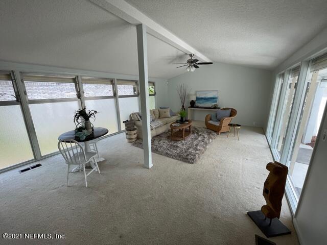 7124 St Augustine Road Jacksonville, FL 32217 - Photo 17 of 20 a living room with furniture a window and a flat screen tv
