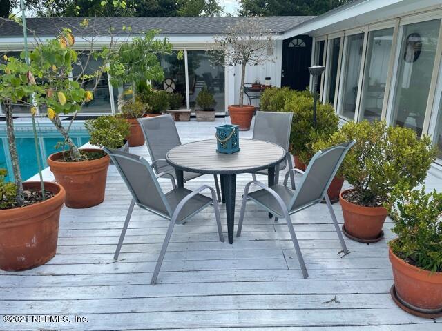 7124 St Augustine Road Jacksonville, FL 32217 - Photo 19 of 20 a view of a patio with table and chairs potted plants