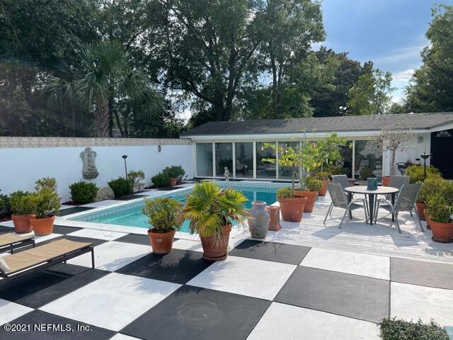 7124 St Augustine Road Jacksonville, FL 32217 - Photo 20 of 20 a view of a house with backyard sitting area and garden
