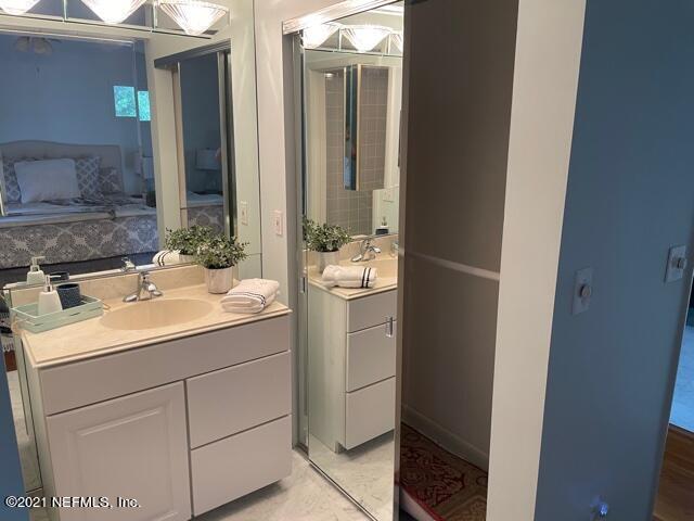 7124 St Augustine Road Jacksonville, FL 32217 - Photo 7 of 20 a bathroom with a sink and mirror