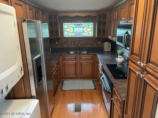 7124 St Augustine Road Jacksonville, FL 32217 - Photo 8 of 20 a kitchen with stainless steel appliances granite countertop a refrigerator a stove a sink and a window