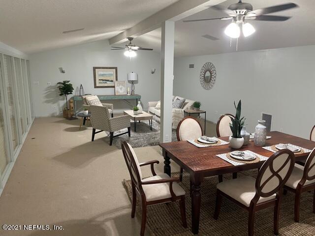 7124 St Augustine Road Jacksonville, FL 32217 - Photo 9 of 20 a view of a dining room with furniture and chandelier