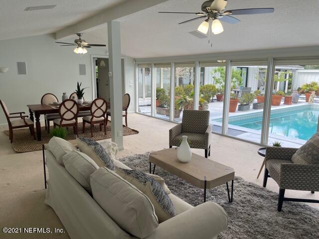 7124 St Augustine Road Jacksonville, FL 32217 - Photo 10 of 20 a living room with furniture and a large window