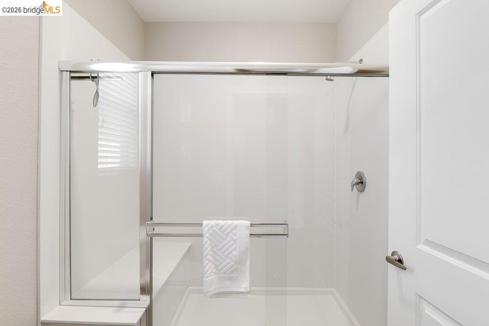 4347 Canada Way Rio Vista, CA 94571 - Photo 25 of 41 Enclosed shower stall featuring clear glass sliding doors with a chrome frame, an integrated bench, and a brushed nickel shower fixture