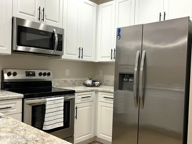 a kitchen with a refrigerator stove and microwave