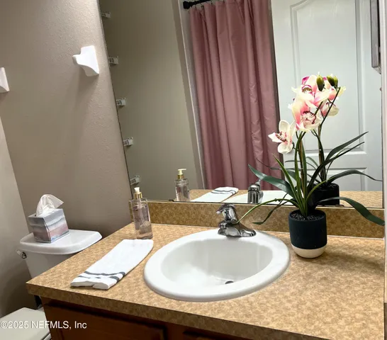 a bedroom with bed and wooden floor