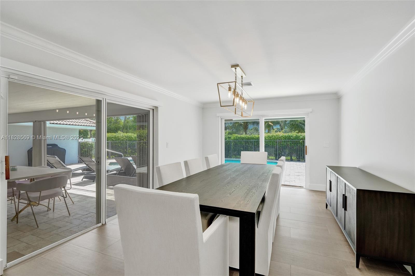 5854 Pinebrook Drive Boca Raton, FL 33433 - Photo 20 of 76 a view of a dining room with furniture large windows and wooden floor