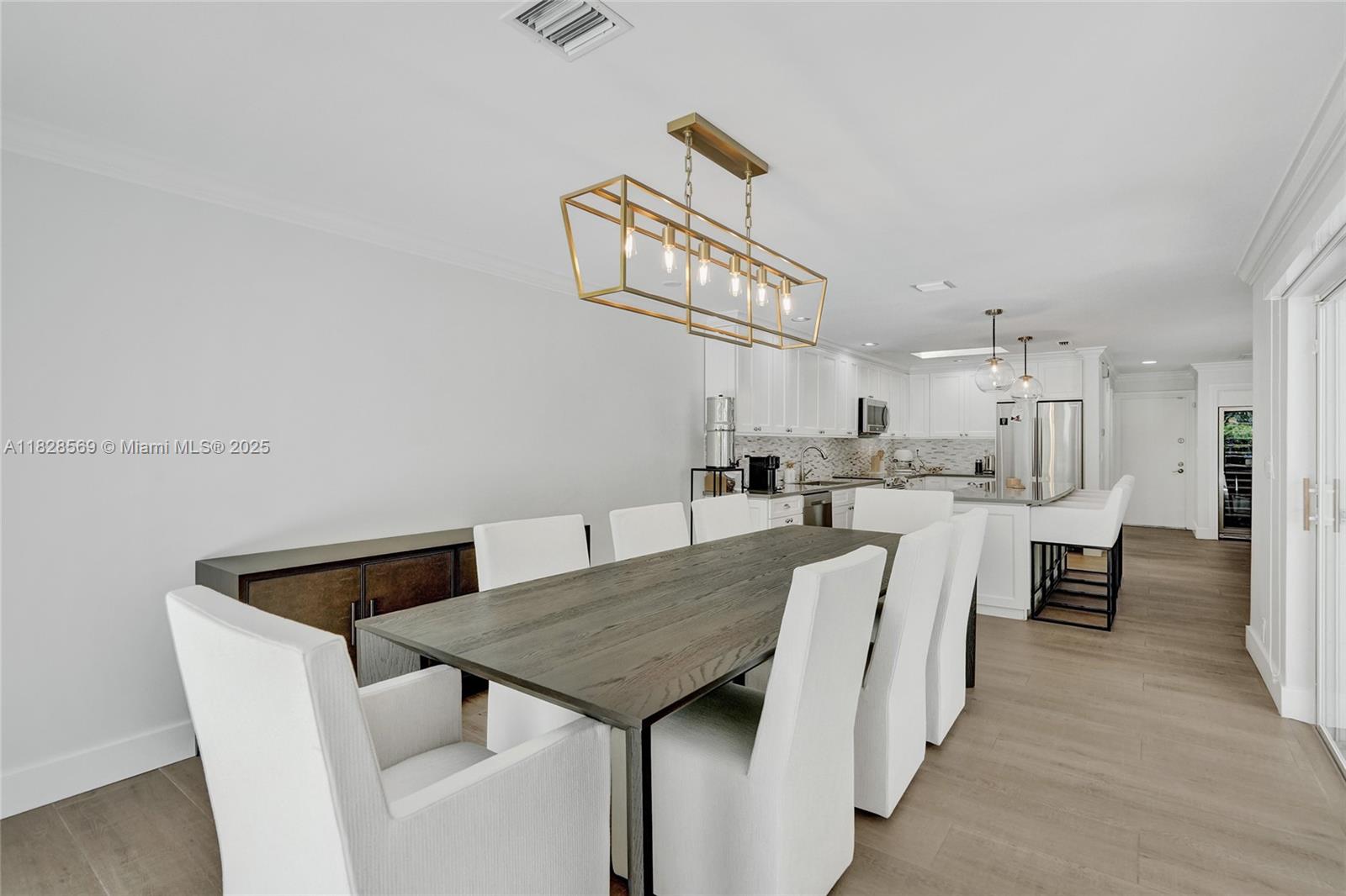 5854 Pinebrook Drive Boca Raton, FL 33433 - Photo 23 of 76 a living room with stainless steel appliances furniture a rug and a kitchen view