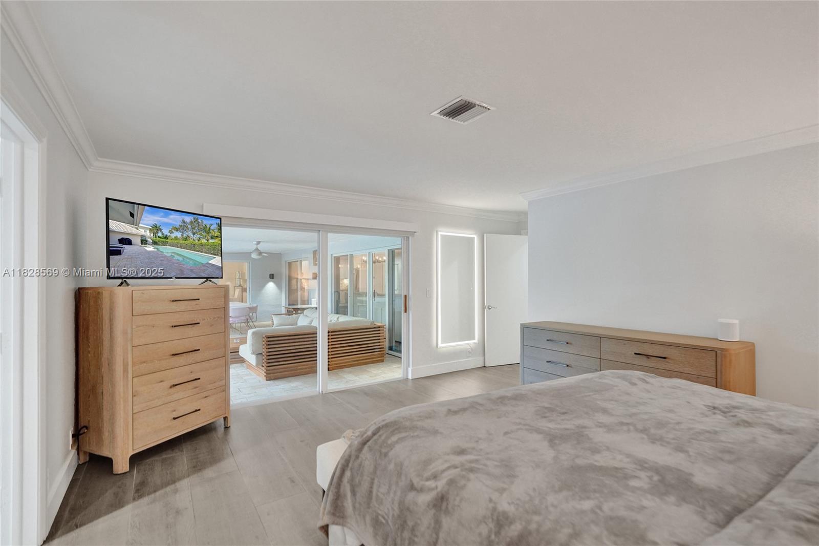 5854 Pinebrook Drive Boca Raton, FL 33433 - Photo 27 of 76 a bedroom with a bed and a dresser