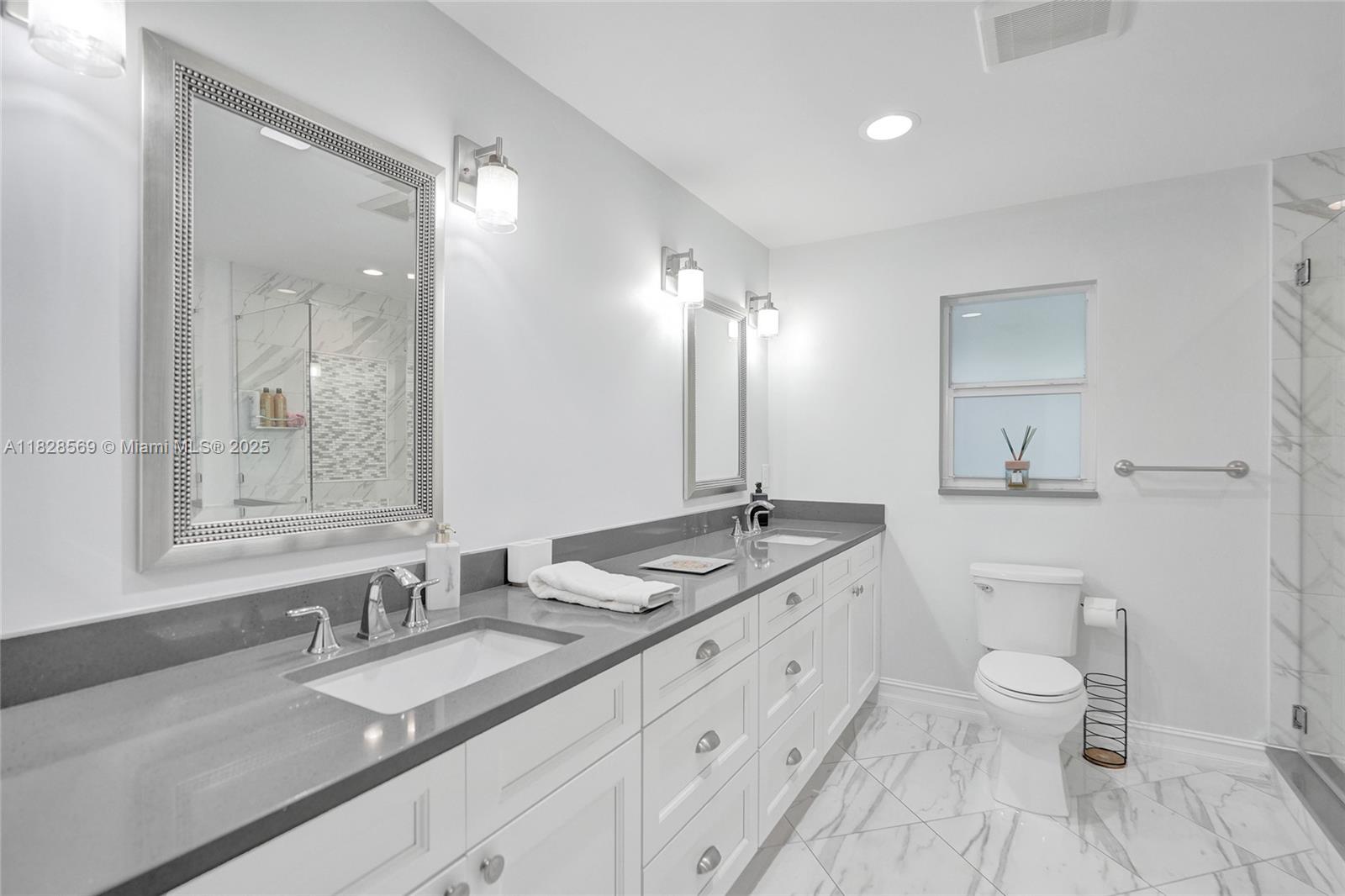 5854 Pinebrook Drive Boca Raton, FL 33433 - Photo 30 of 76 a bathroom with a granite countertop double vanity sink a mirror and a toilet
