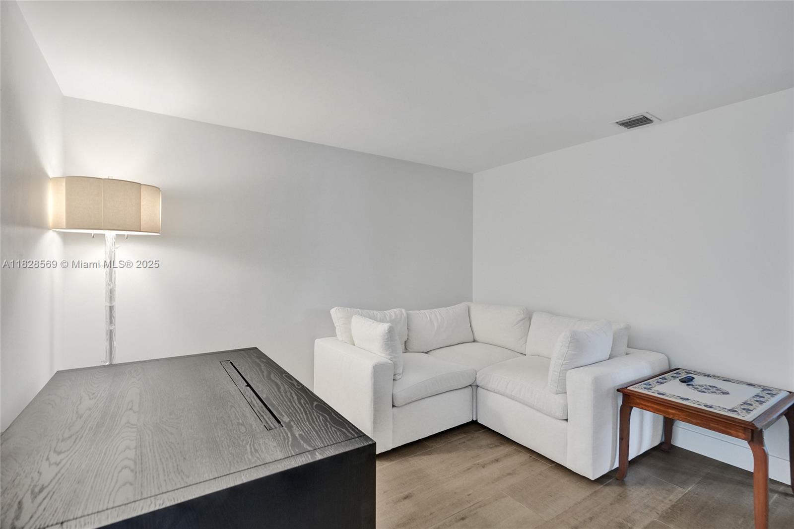 5854 Pinebrook Drive Boca Raton, FL 33433 - Photo 35 of 76 a living room with furniture and a lamp