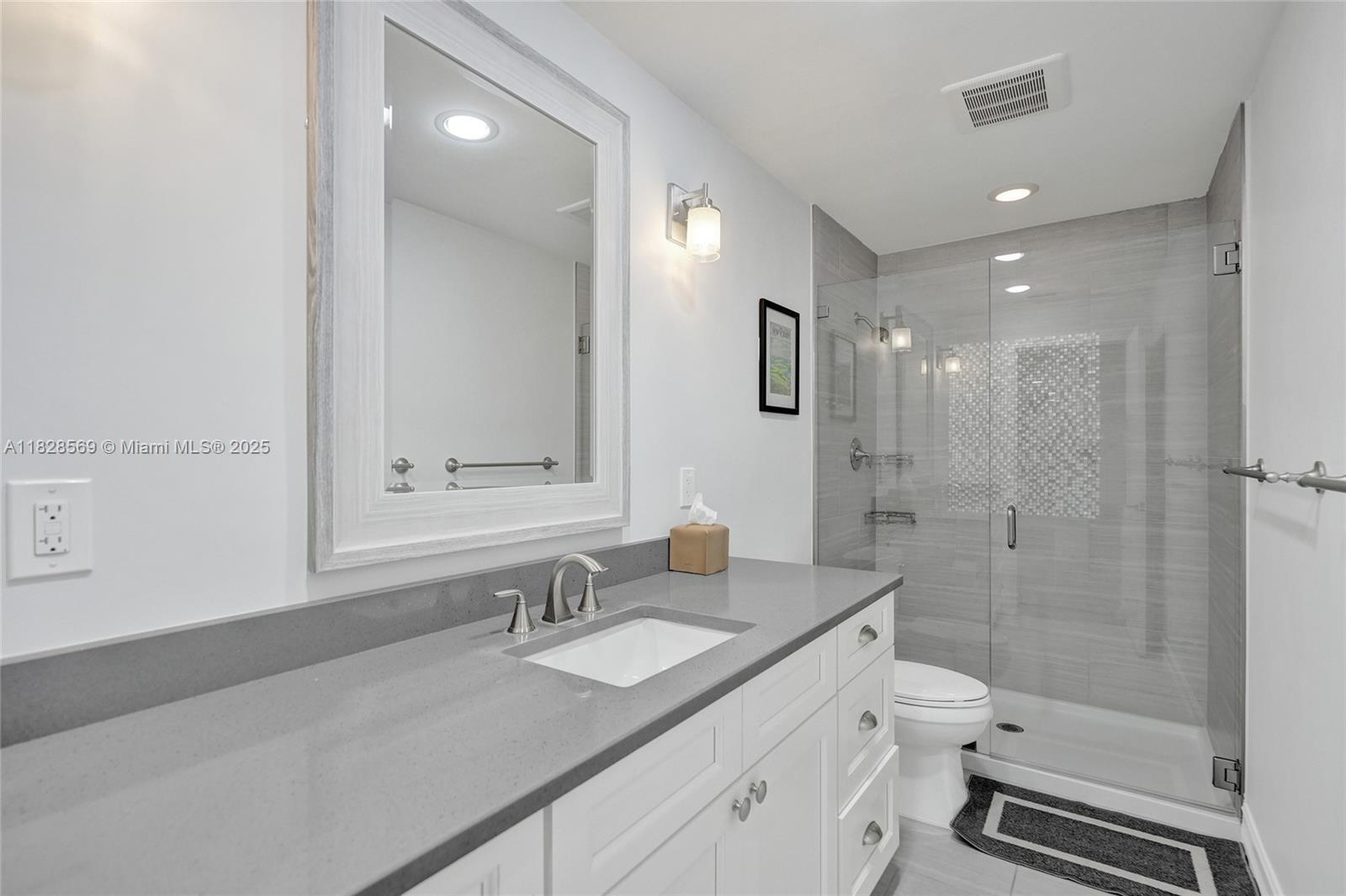5854 Pinebrook Drive Boca Raton, FL 33433 - Photo 36 of 76 a bathroom with a shower sink vanity granite and toilet