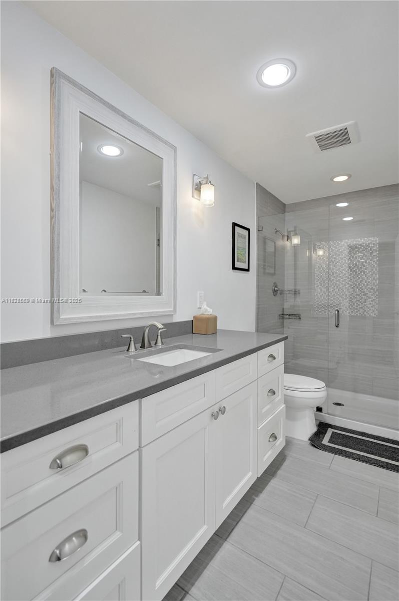 5854 Pinebrook Drive Boca Raton, FL 33433 - Photo 37 of 76 a bathroom with a granite countertop sink mirror and toilet