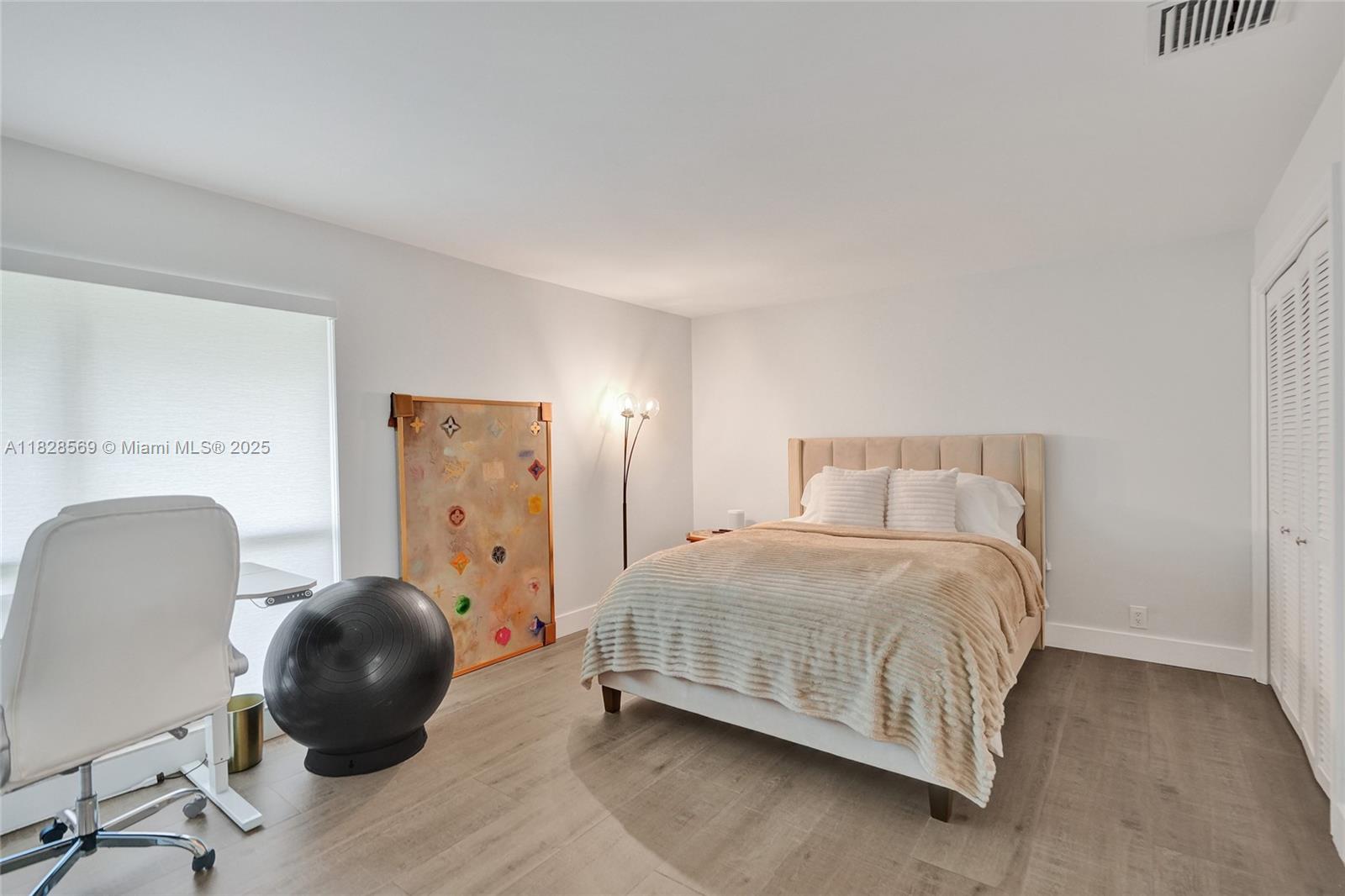 5854 Pinebrook Drive Boca Raton, FL 33433 - Photo 39 of 76 a bedroom with a bed and a chair