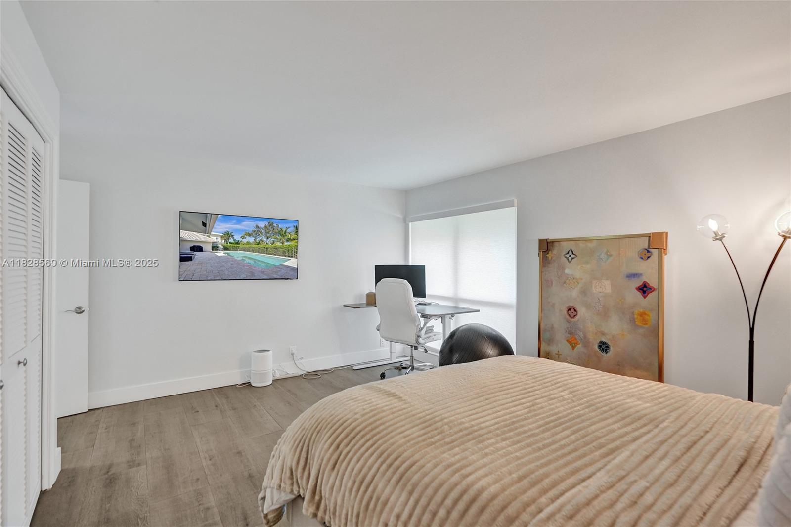 5854 Pinebrook Drive Boca Raton, FL 33433 - Photo 40 of 76 a bedroom with a bed and a mirror