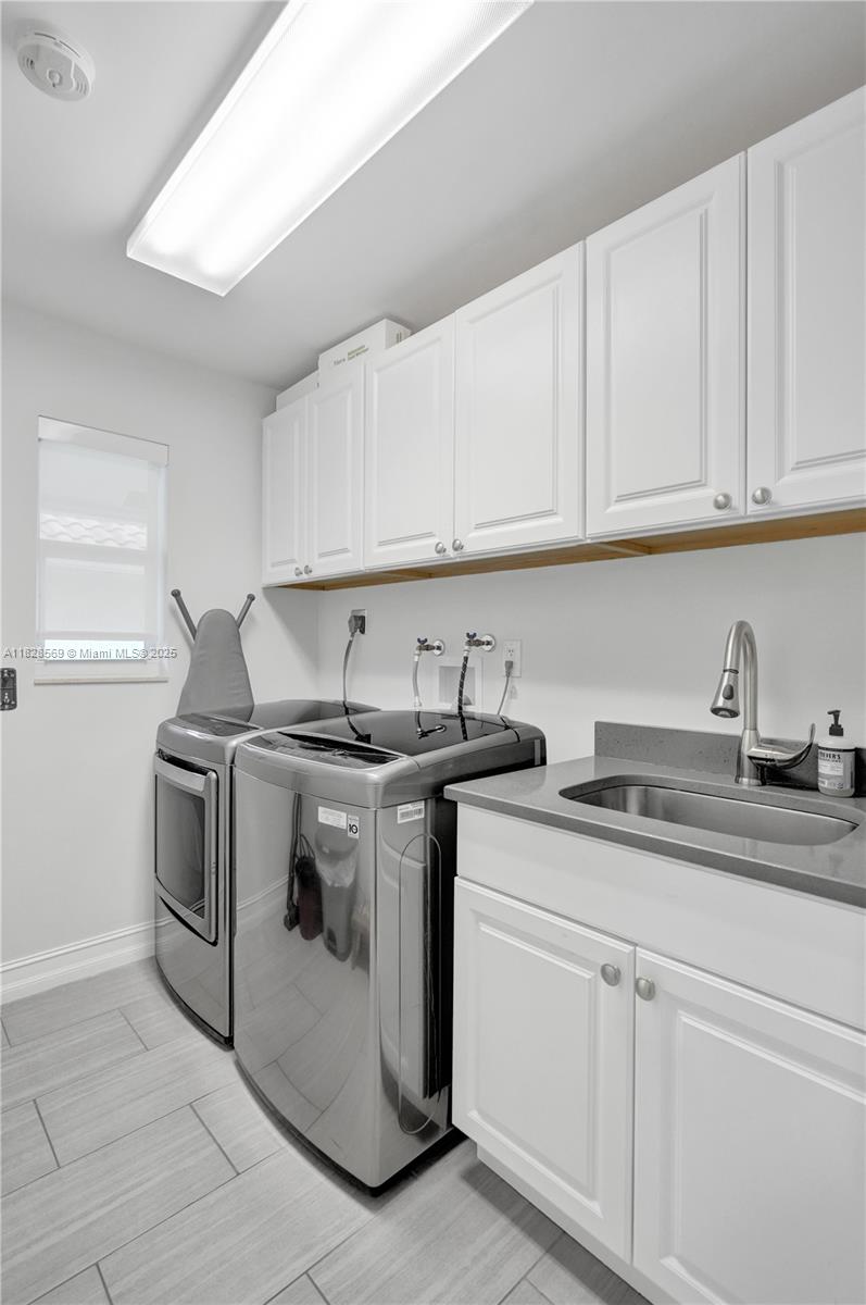 5854 Pinebrook Drive Boca Raton, FL 33433 - Photo 43 of 76 a kitchen with granite countertop white cabinets and white appliances