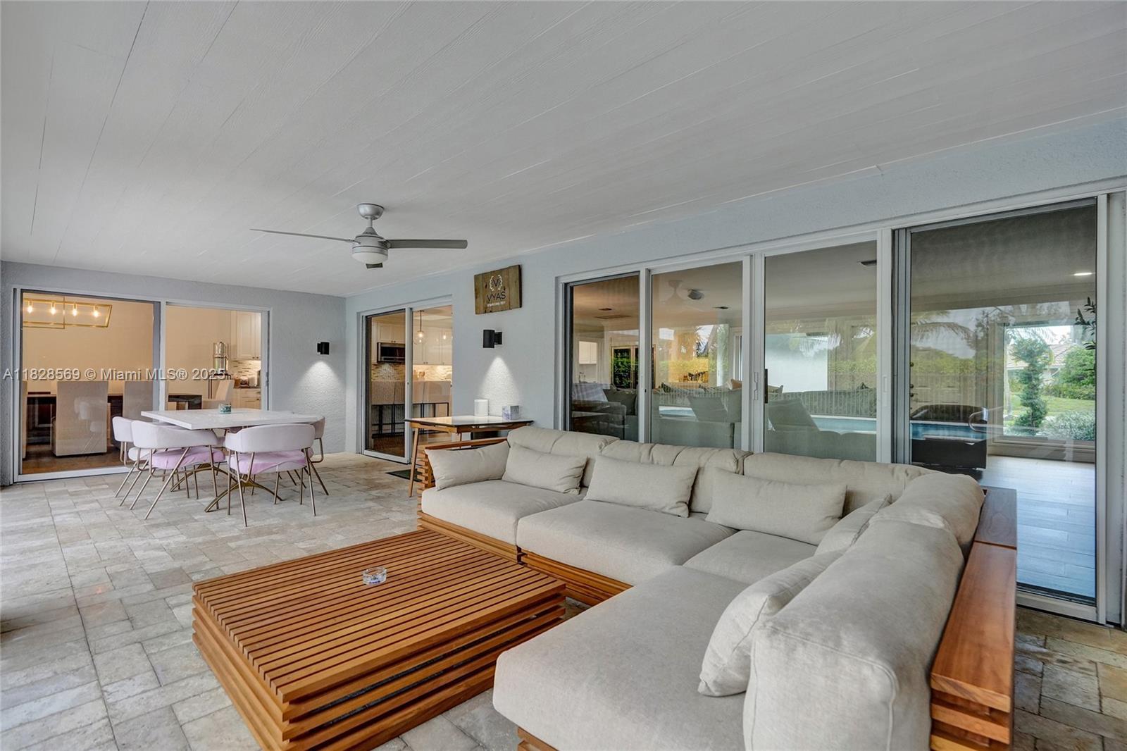 5854 Pinebrook Drive Boca Raton, FL 33433 - Photo 45 of 76 a living room with furniture and a large window