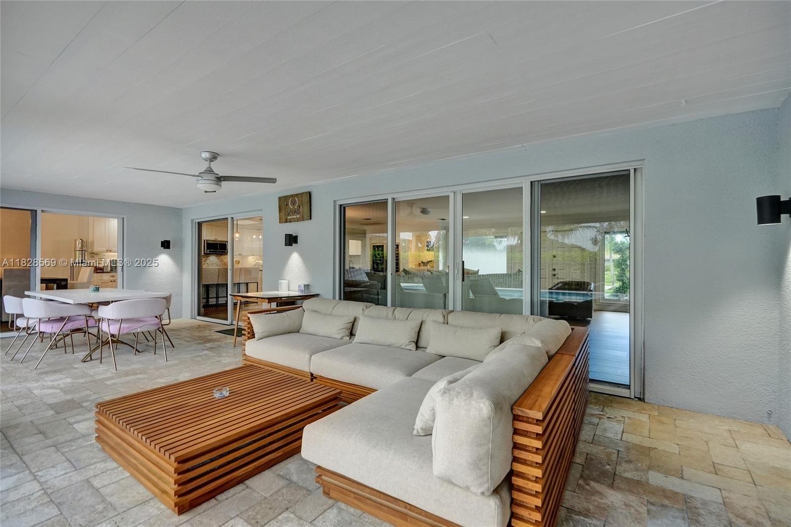 5854 Pinebrook Drive Boca Raton, FL 33433 - Photo 46 of 76 a living room with furniture a rug and a large window