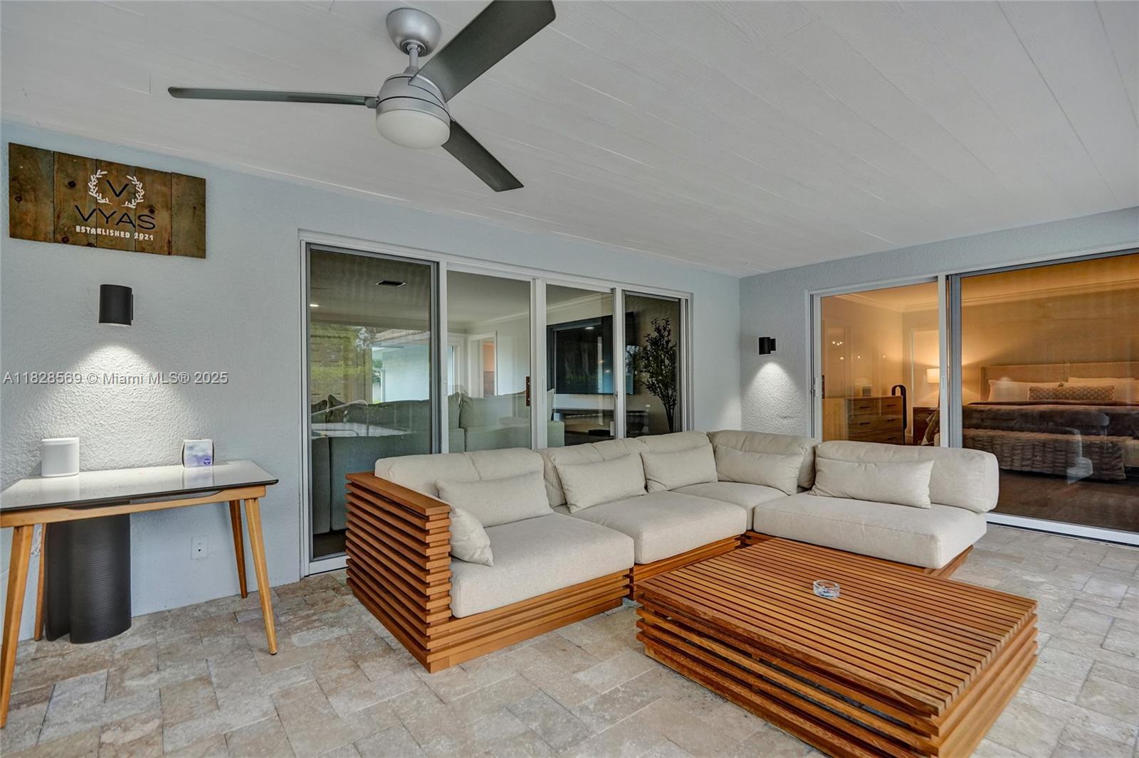 5854 Pinebrook Drive Boca Raton, FL 33433 - Photo 47 of 76 a living room with furniture a table and a large window