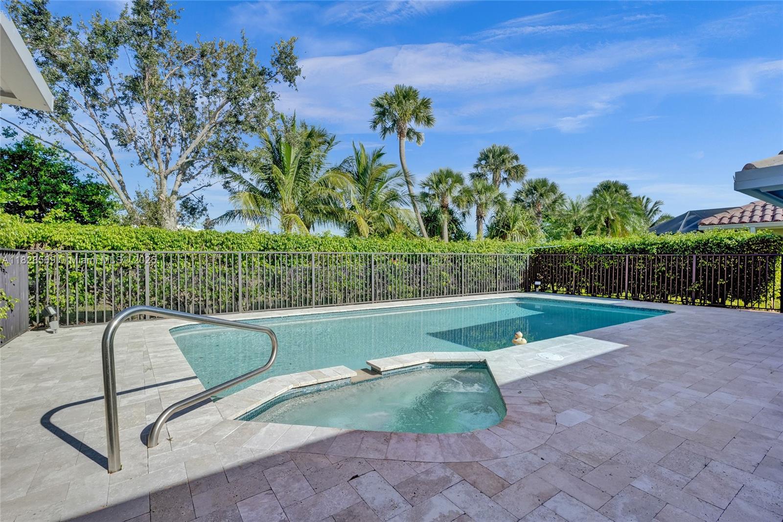5854 Pinebrook Drive Boca Raton, FL 33433 - Photo 51 of 76 Heated chlorine pool complemented by a relaxing Jacuzzi spa, creating the perfect oasis for year-round enjoyment.