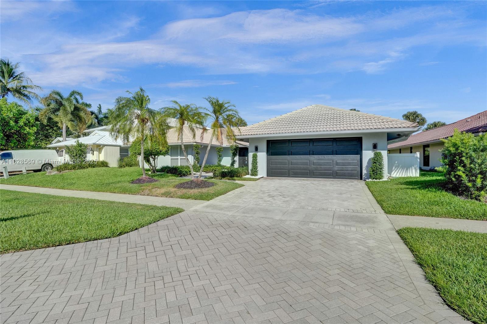 5854 Pinebrook Drive Boca Raton, FL 33433 - Photo 61 of 76 a front view of a house with a yard