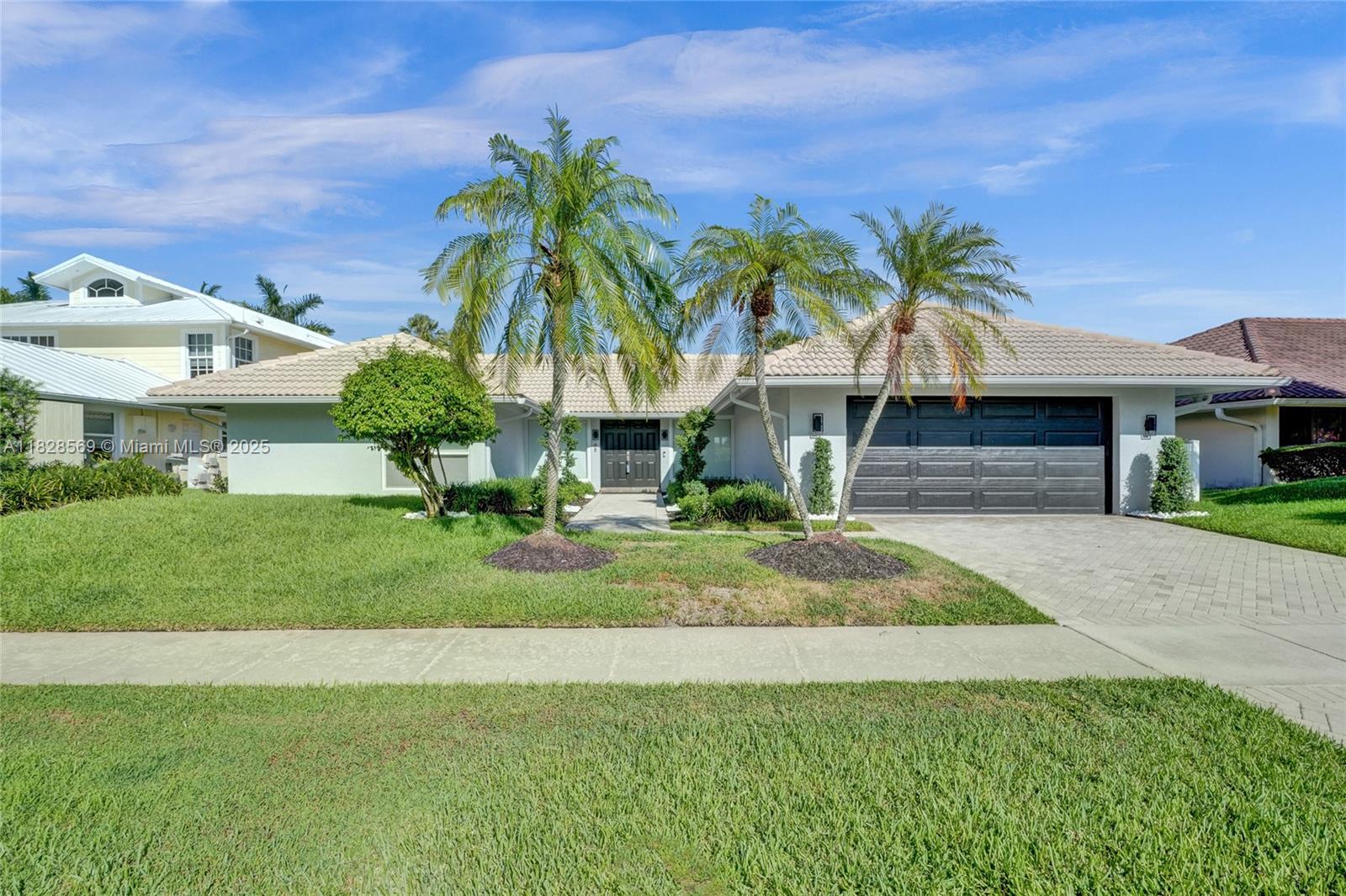 5854 Pinebrook Drive Boca Raton, FL 33433 - Photo 63 of 76 a front view of a house with a yard and garage