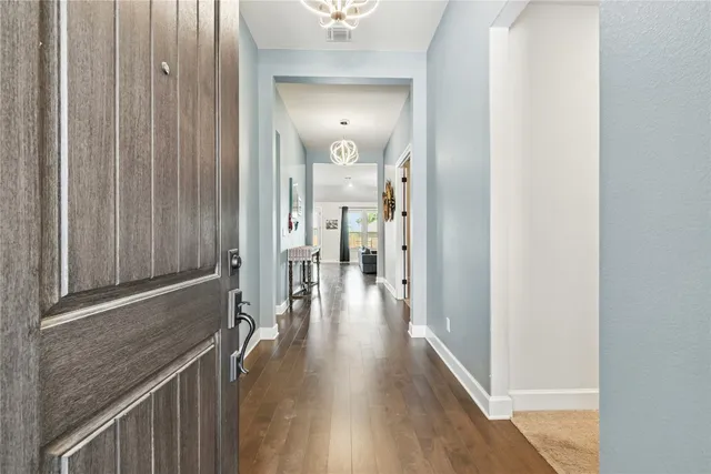 a view of hallway with wooden floor