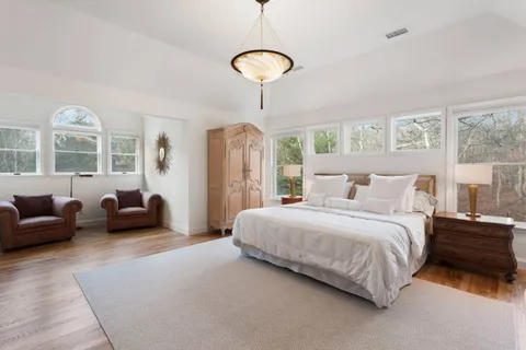 a bedroom with bed and a couch