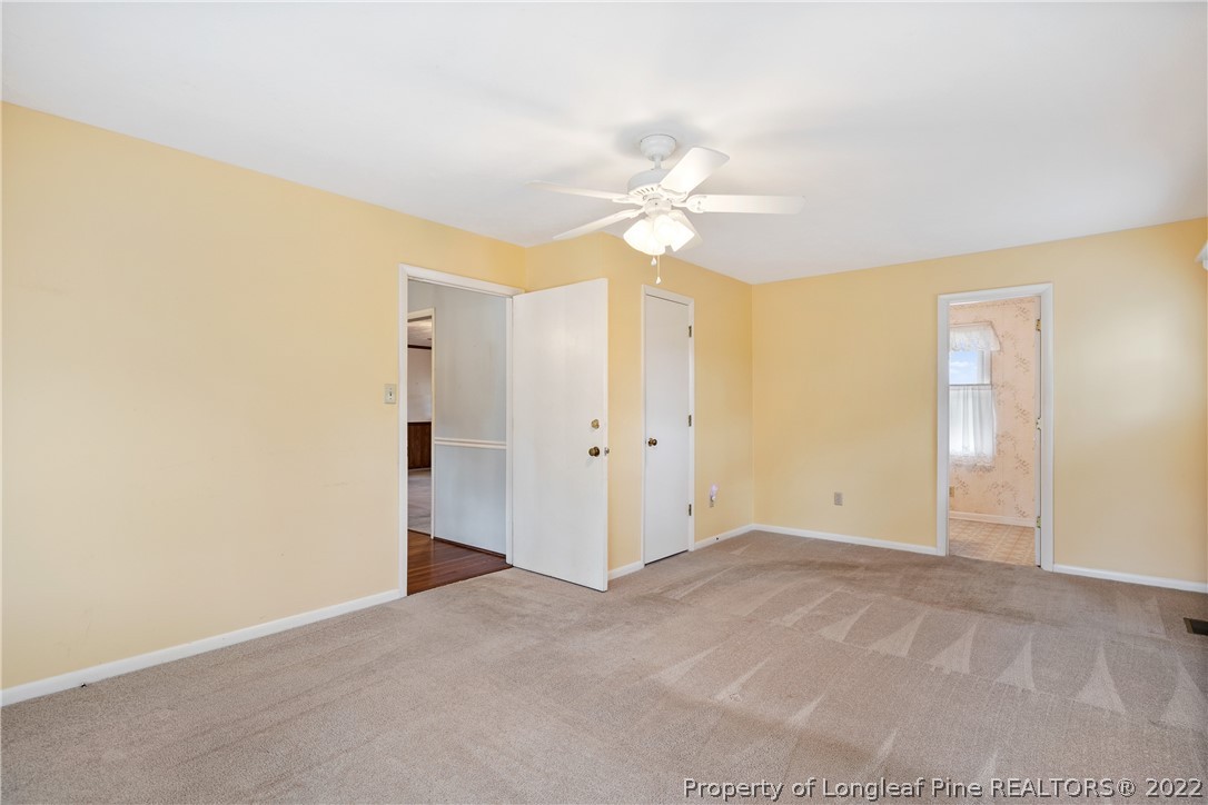 7876 Maxwell Road Stedman, NC 28391 - Photo 20 of 50 an empty room with a ceiling fan and a window