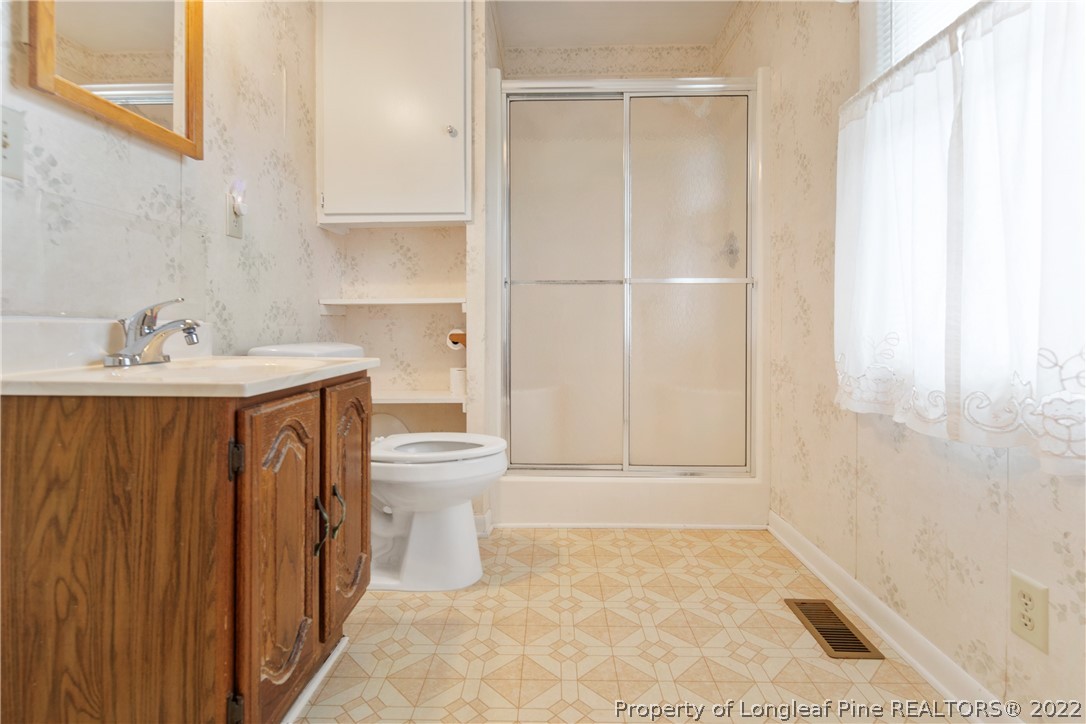 7876 Maxwell Road Stedman, NC 28391 - Photo 23 of 50 a bathroom with a sink a toilet and shower
