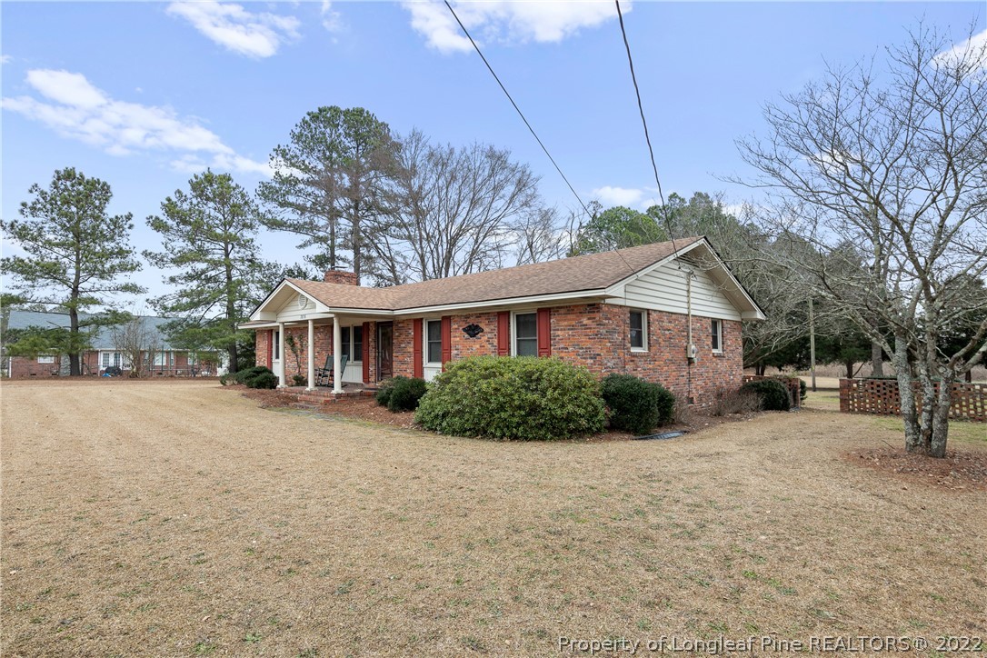 7876 Maxwell Road Stedman, NC 28391 - Photo 3 of 50 a front view of a house with a garden