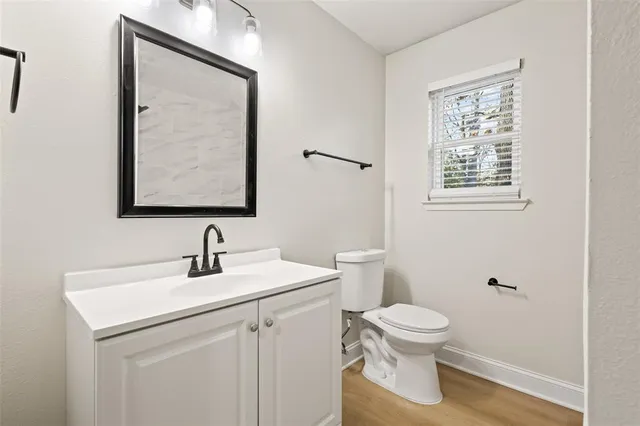 a bathroom with a toilet sink and mirror