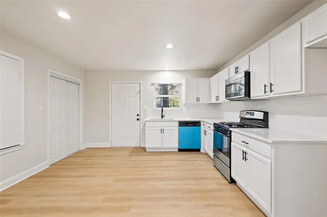a kitchen with stainless steel appliances granite countertop a stove and a sink