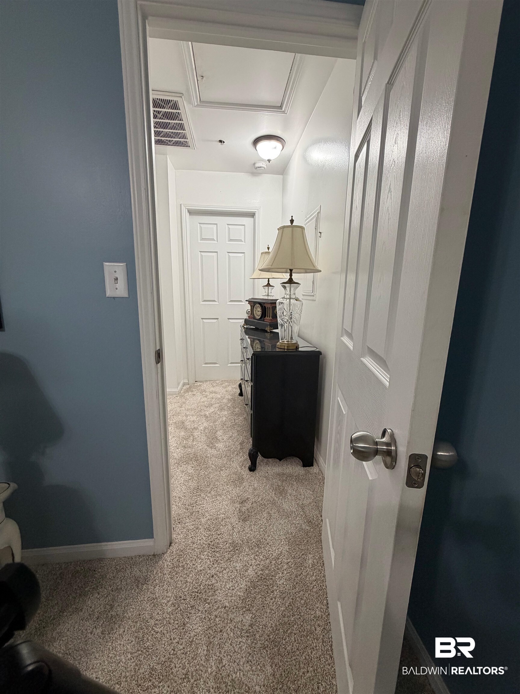 1517 Regency Road, Unit 71 Gulf Shores, AL 36542 - Photo 11 of 26 Hall with light carpet and baseboards