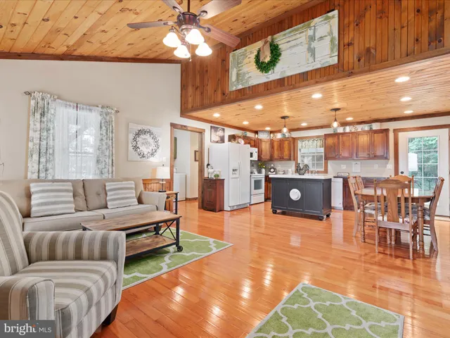 a view of a hallway with bathroom and wooden floor