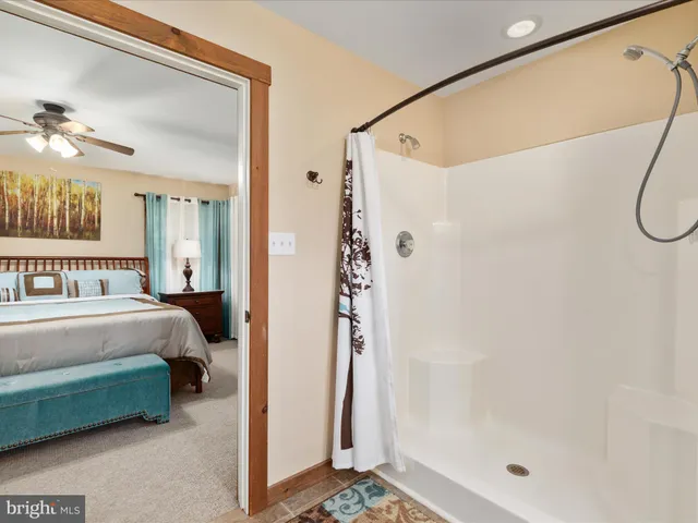 a bathroom with a sink a toilet and a shower