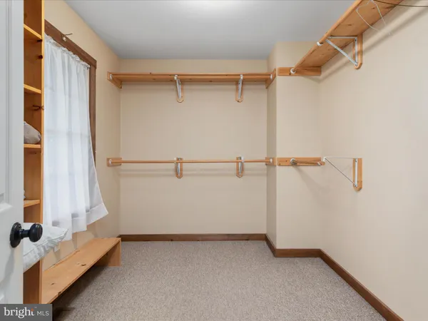 a view of a porch with furniture and a yard
