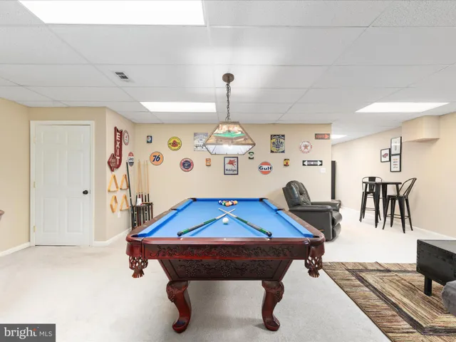 a front view of a house with swimming pool and green space