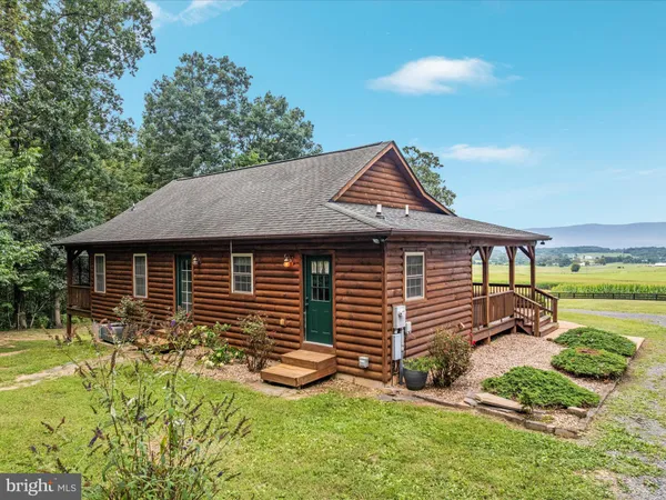 a front view of a house with a yard and sitting area