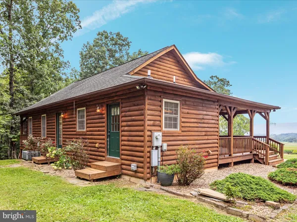 a front view of a house with a garden and yard