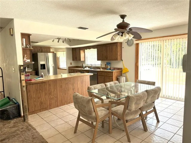 a large white kitchen with a sink and cabinets
